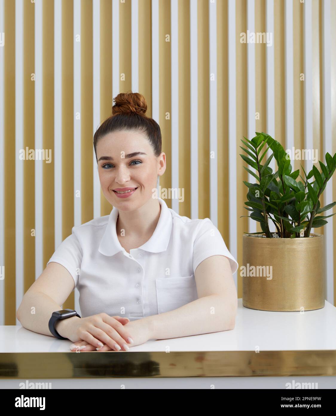 female-receptionist-at-reception-desk-in-a-modern-office-lobby-stock