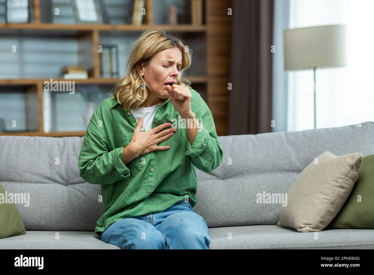 An attack of asthma, allergies at home. An elderly woman is sitting on