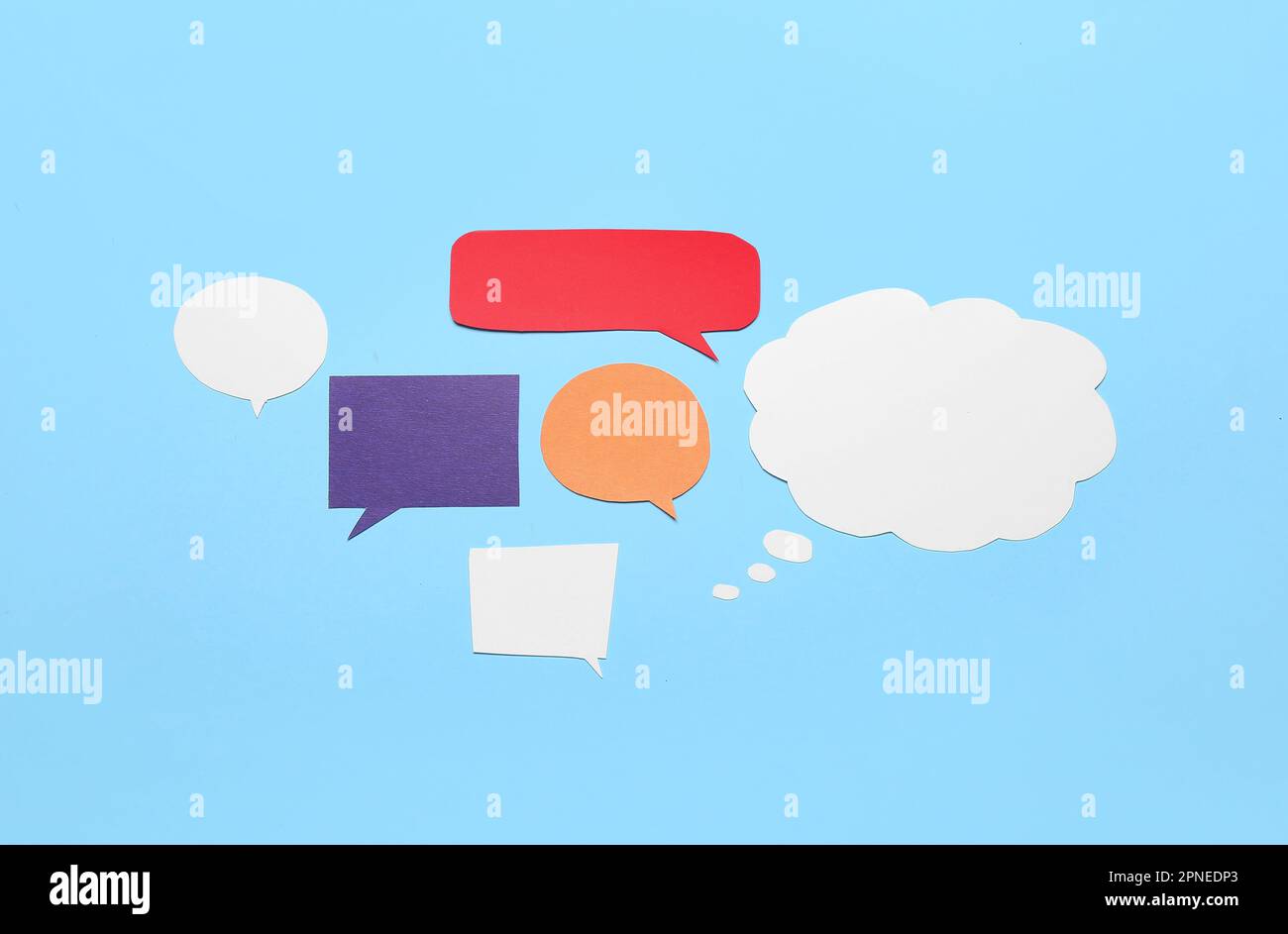 Blank paper speech bubbles on blue background Stock Photo