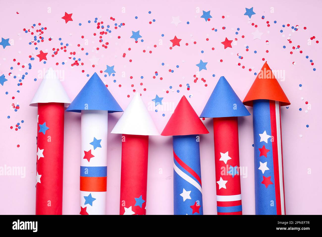 Firework rockets and confetti for Independence Day on lilac background ...