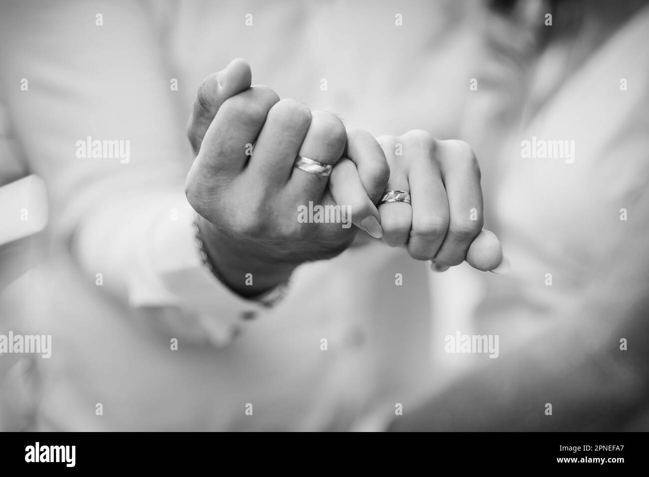 Wedding rings on the hands of the newlyweds. Gold rings on the hand of a man and a woman Stock Photo