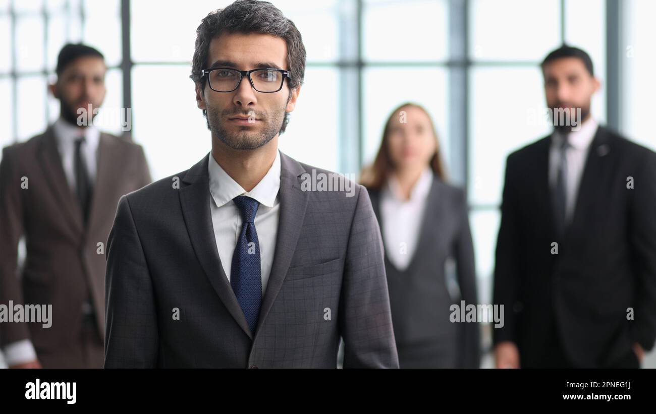 company workers standing in a row in creative office, posing on camera Stock Photo