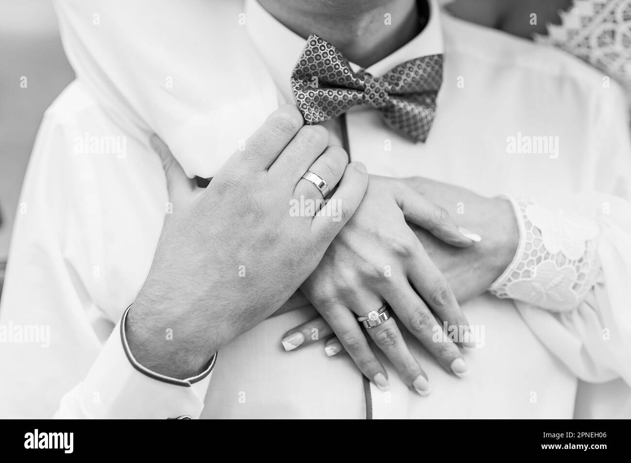 Wedding rings on the hands of the newlyweds. Gold rings on the hand of a man and a woman Stock Photo
