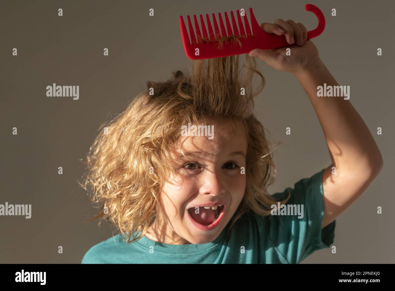 Tangled kids hair. Kid brushing tangled hair. Funny kids haircut Stock