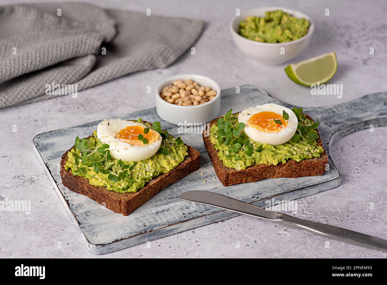 Food photography of sandwich with rye bread, egg, avocado, cress salad