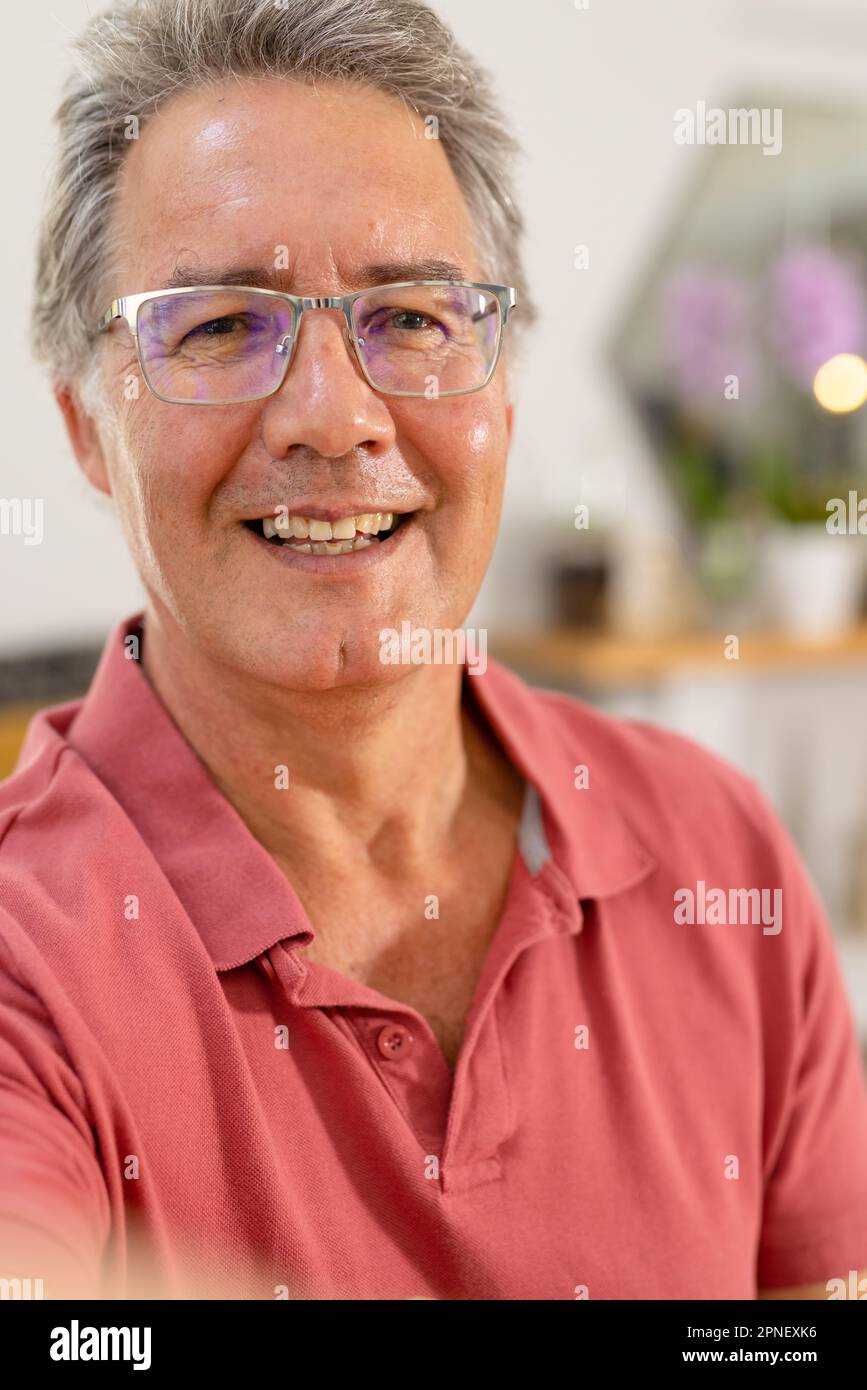 Closeup portrait of caucasian smiling senior man wearing glasses at home, copy space Stock Photo