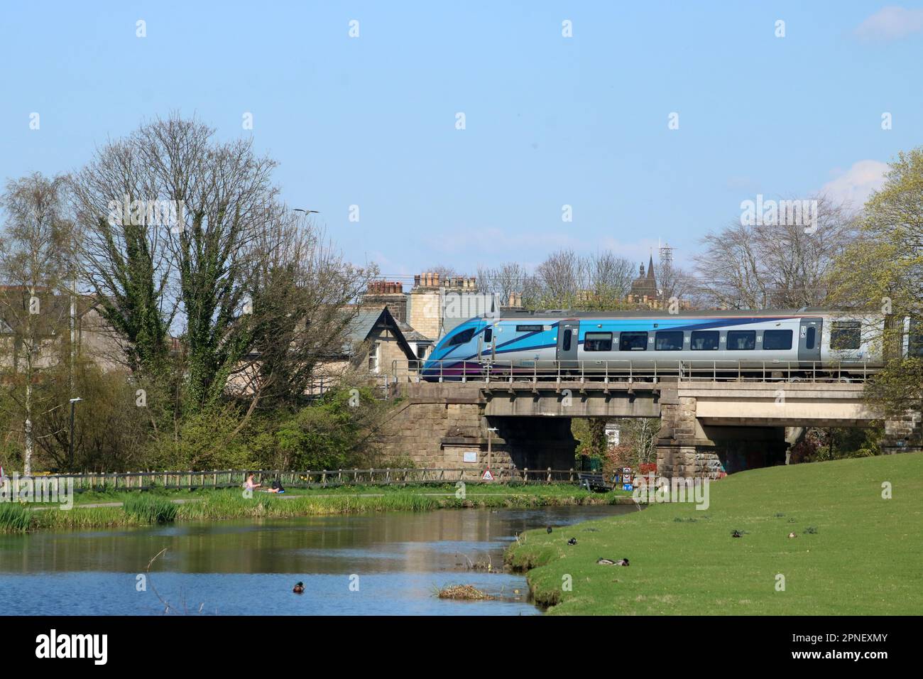 TransPennine Express class 397 civity Nova 2 electric multiple-unit on the West Coast Main Line in Lancaster crossing Lancaster canal 18th April 2023. Stock Photo