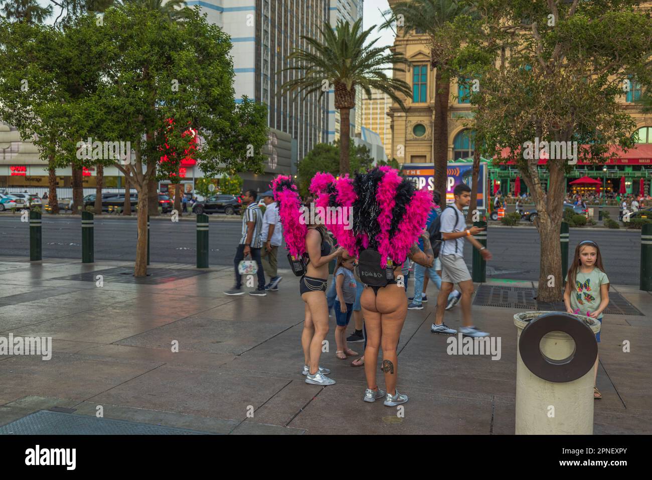 Entertainment girls in colorful costumes inviting tourists for evening performances. Las Vegas Strip, USA. Stock Photo