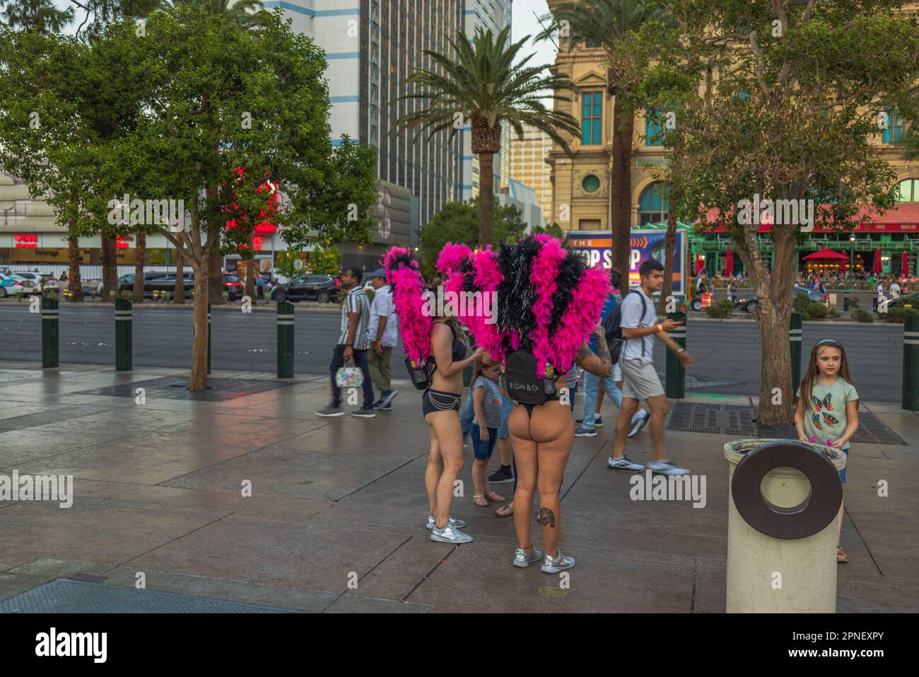 Entertainment girls in colorful costumes inviting tourists for evening