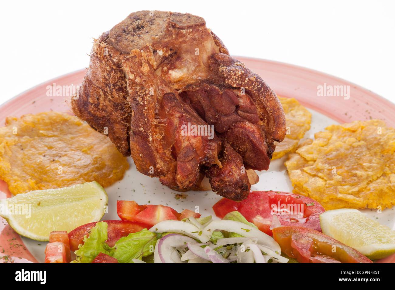 Fried Pork Knuckle With Salad And Patacones. Stock Photo