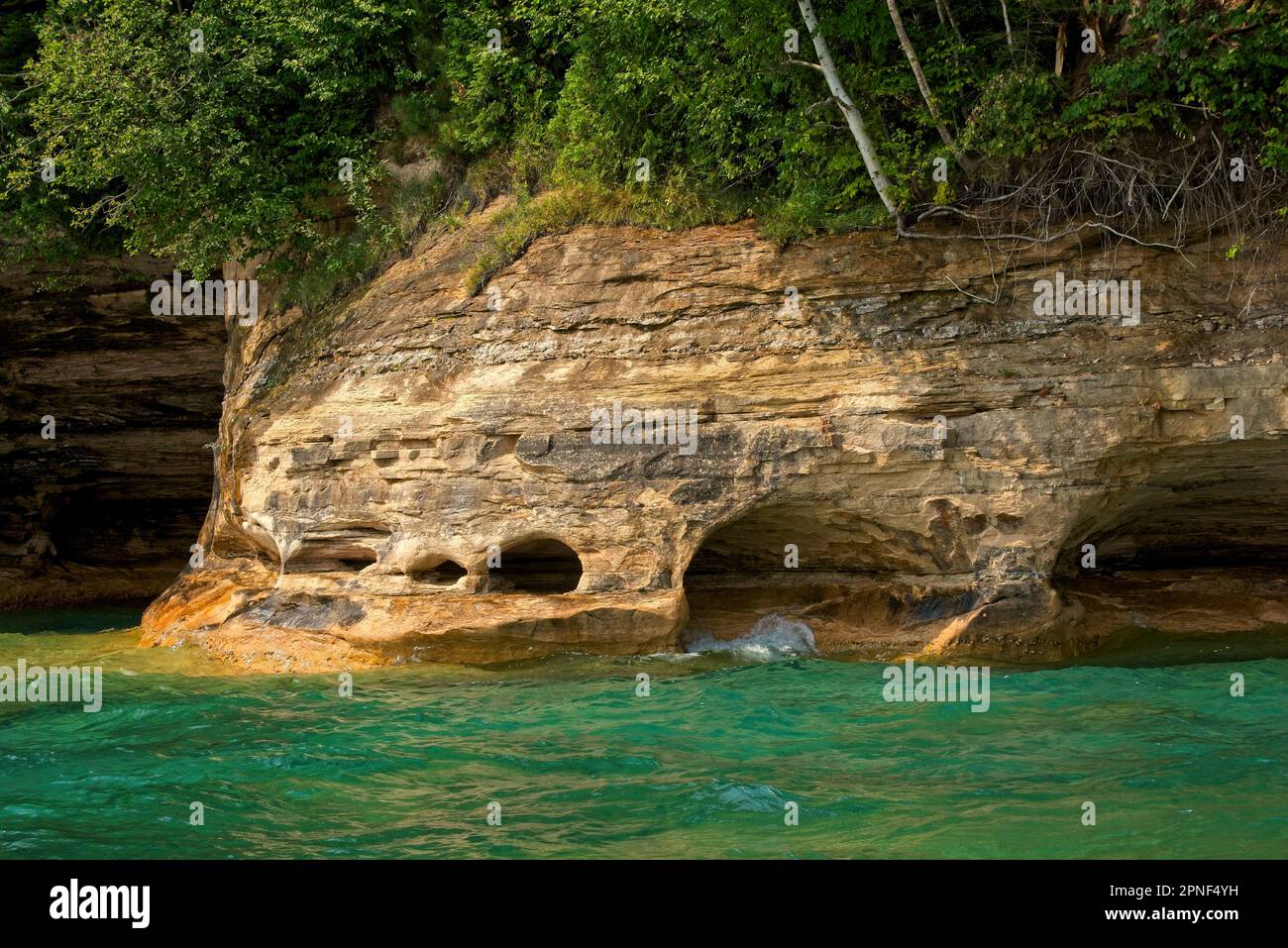 Wavecarved caves at the base of cliffs on Grand Island, Michigan, on