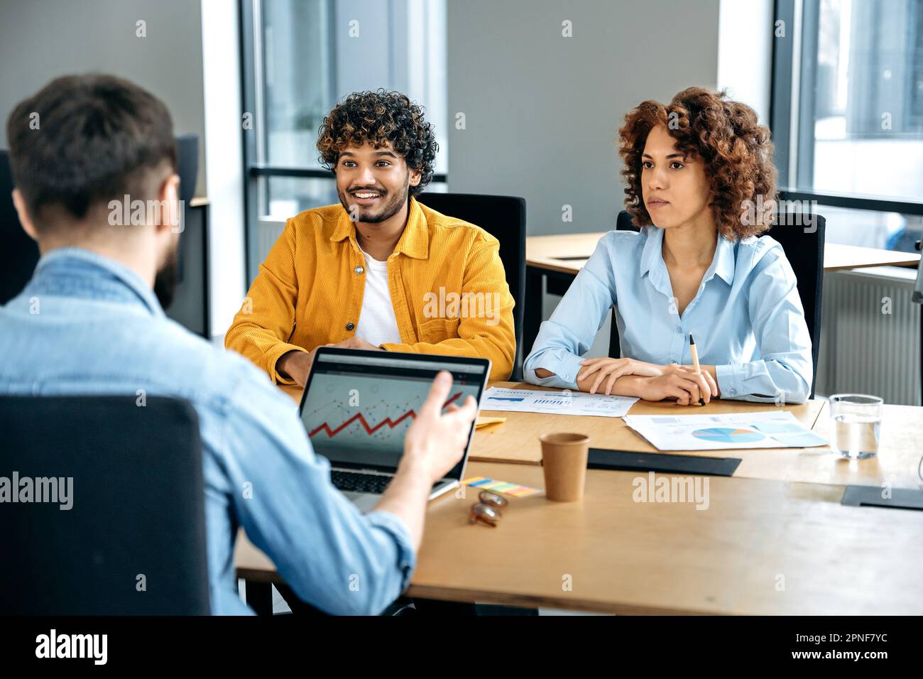 Successful positive multiracial business people, working together in