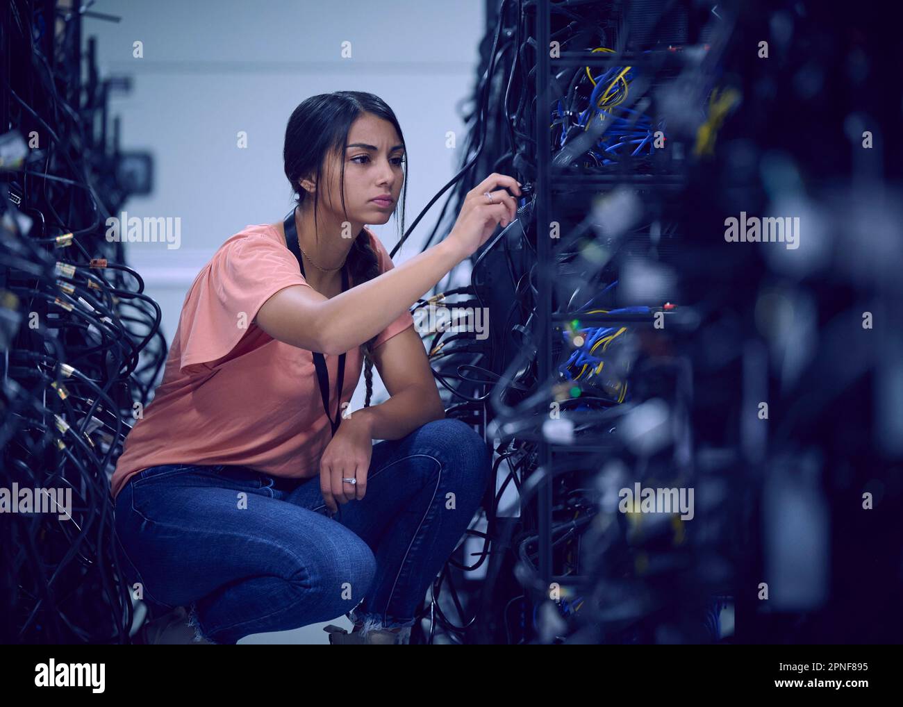 Female technician working in server room Stock Photo Alamy