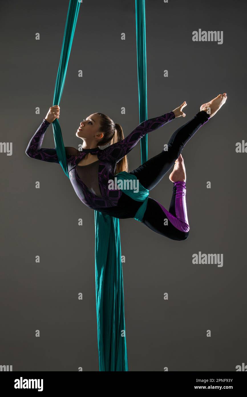 Teenage girl (14-15) practicing aerial silk Stock Photo
