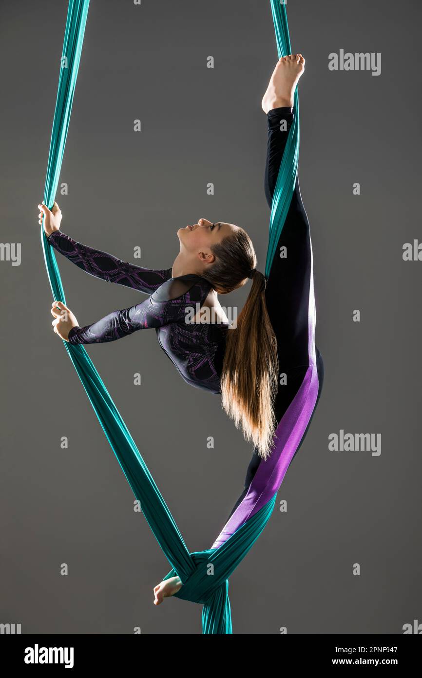 Teenage girl (14-15) practicing aerial silk Stock Photo