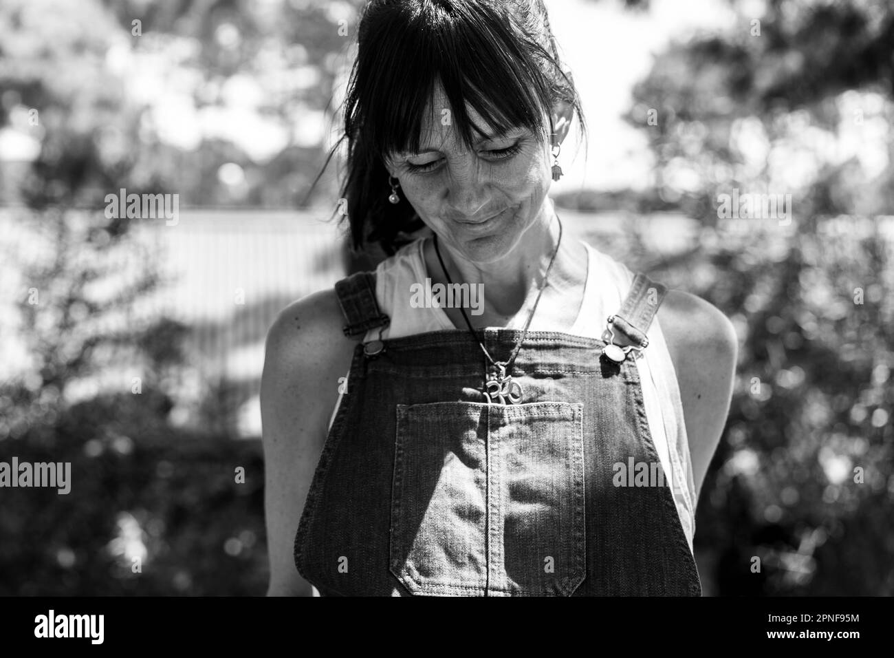 Portrait of a smiling woman looking down. Black and white photography Stock Photo