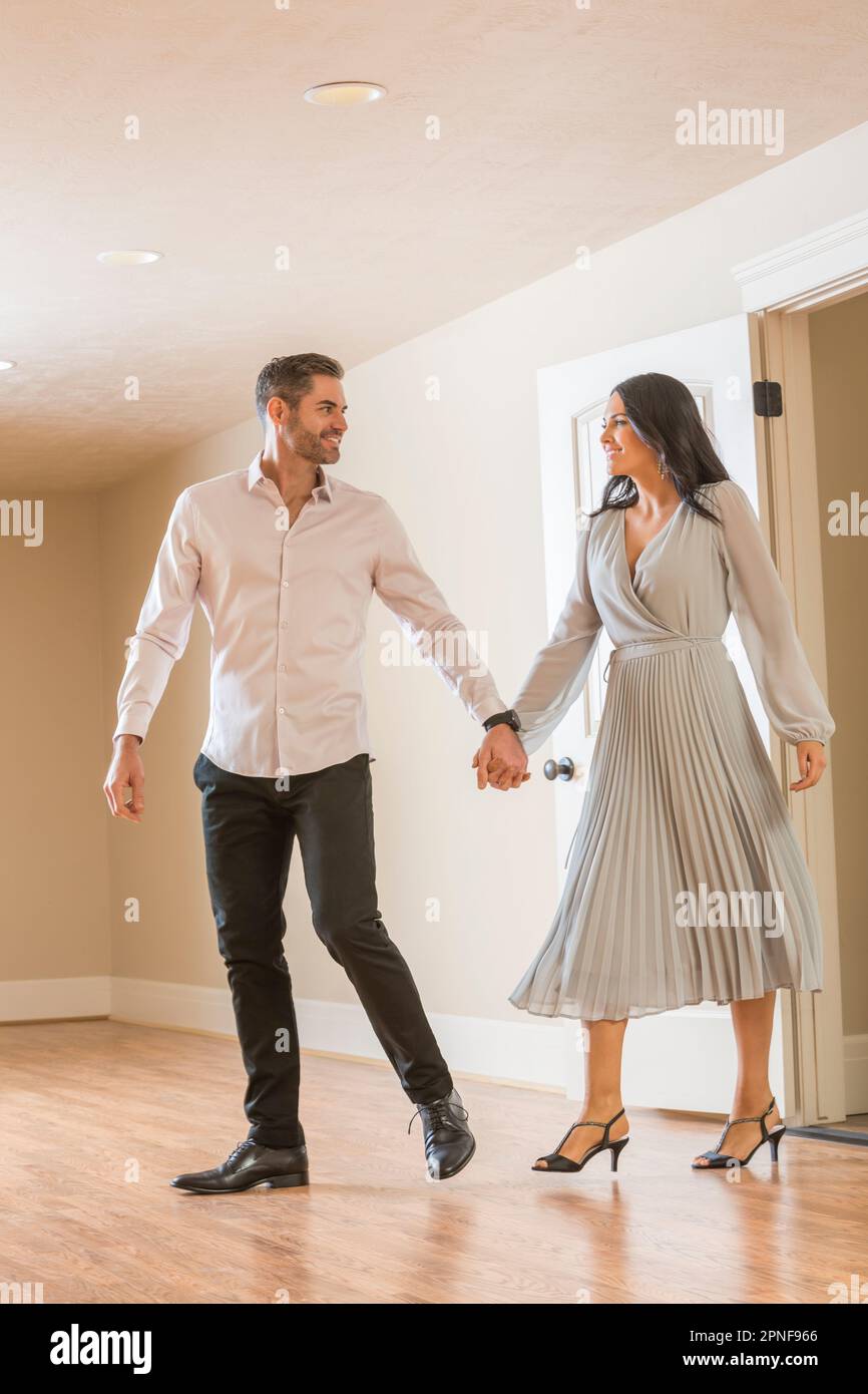 Couple holding hands and walking in to new apartment Stock Photo Alamy
