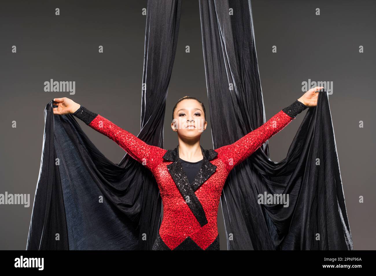 Teenage girl (14-15) performing aerial silk Stock Photo