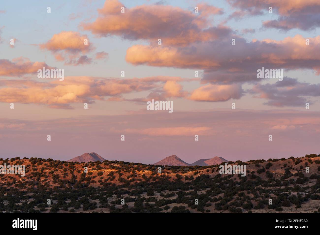 United States, New Mexico, Lamy, Colorful sky over Galisto Basin Preserve at sunset Stock Photo