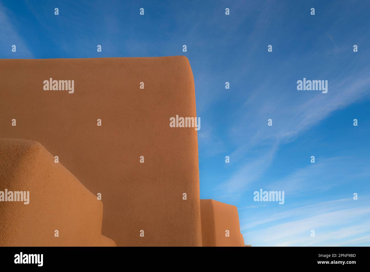 United States, New Mexico, Santa Fe, Adobe style walls against blue sky Stock Photo