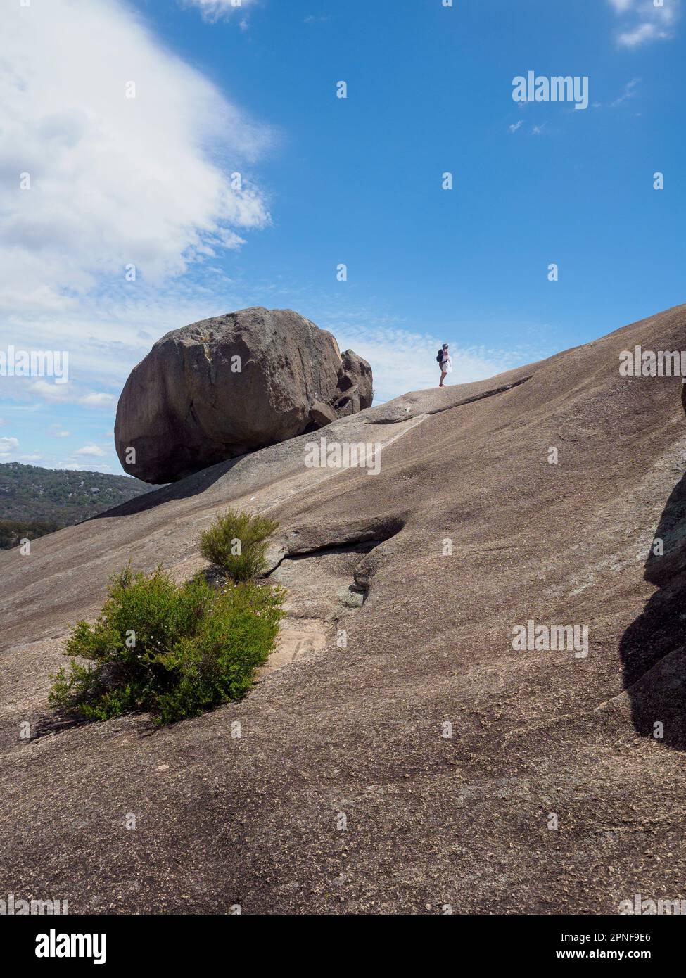 Australia, Queensland, Girraween National Park, Woman hiking on rock formation Stock Photo