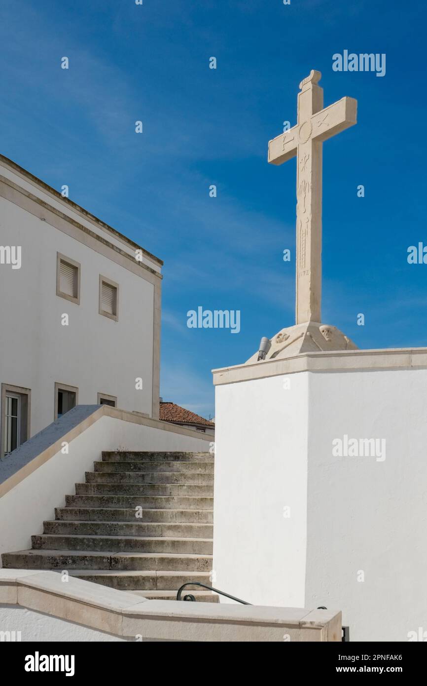 Portugal, Torres Novas, Cross on white church against blue sky Stock Photo