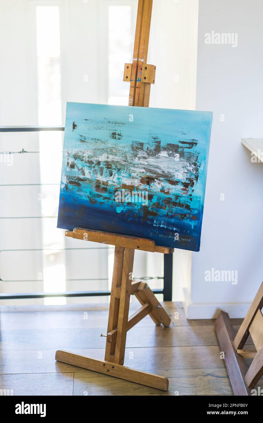 An artist easel with a painted canvas Stock Photo