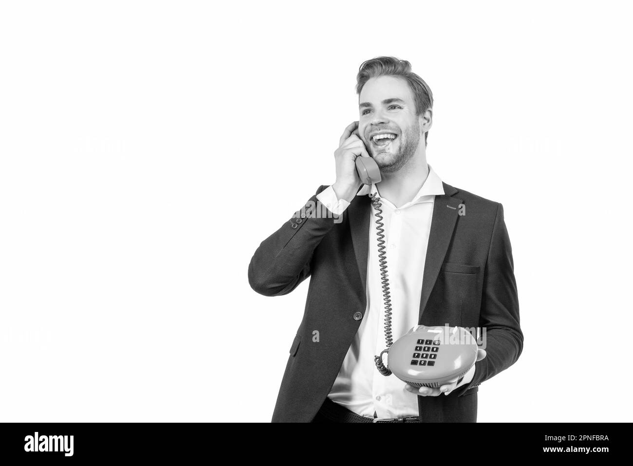 Happy guy talk in vintage telephone receiver holding retro landline phone, communication. Stock Photo