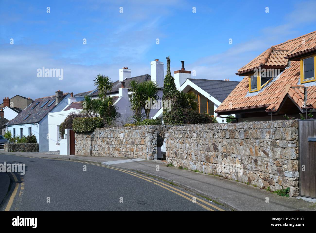 Curving suburban street with villa type houses in a seaside town Stock Photo