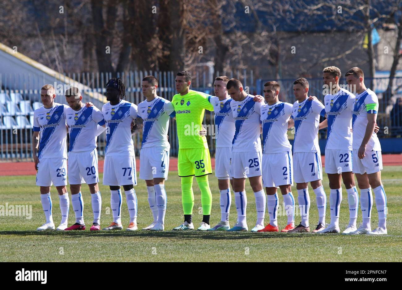 Uzhhorod, Ukraine - March 12, 2023: Dynamo Kyiv players pay tribute during munite of silence for those who died in the war before Ukrainian Premier League game against SC Dnipro-1 at Avanhard stadium Stock Photo
