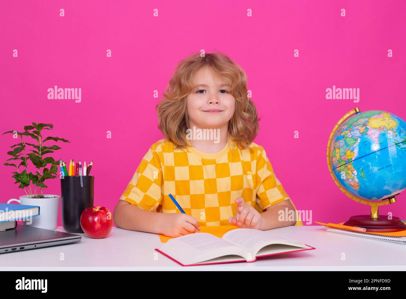 School and kids. Cute blonde child with a book learning. Knowledge day Stock Photo