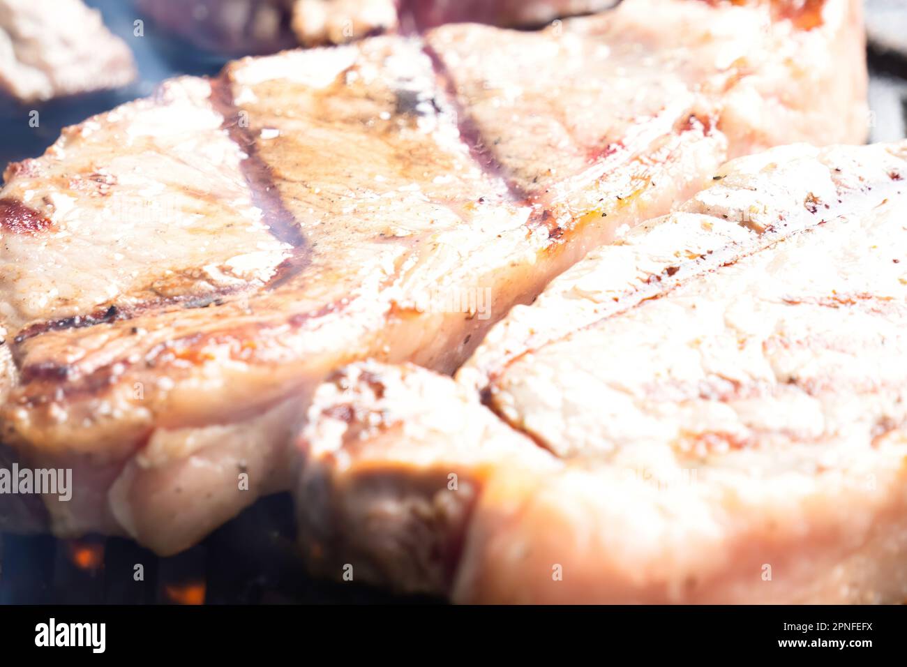 Porterhouse Steaks Grilling On The BBQ Stock Photo Alamy