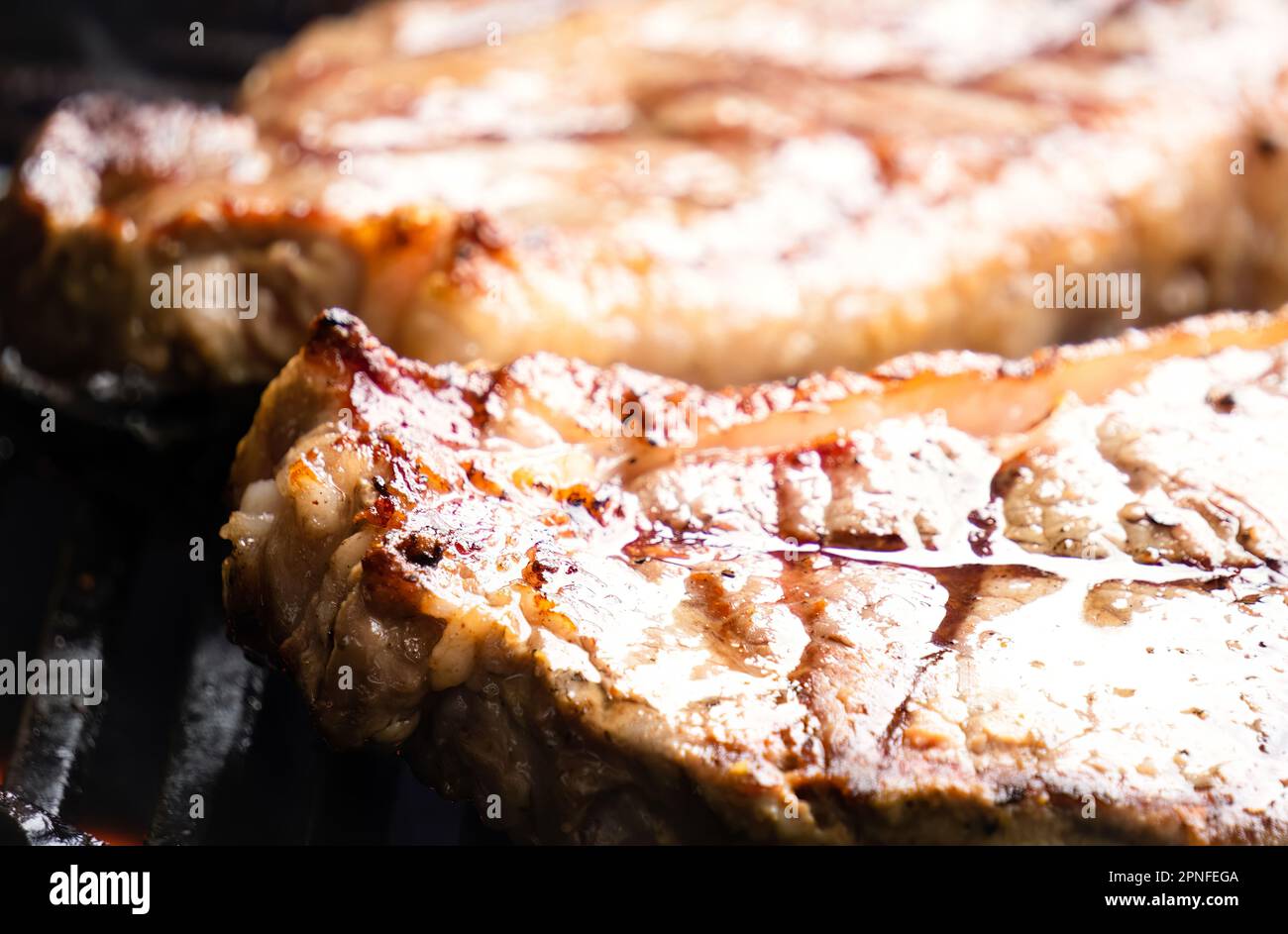Porterhouse Steaks Grilling On The BBQ Stock Photo Alamy