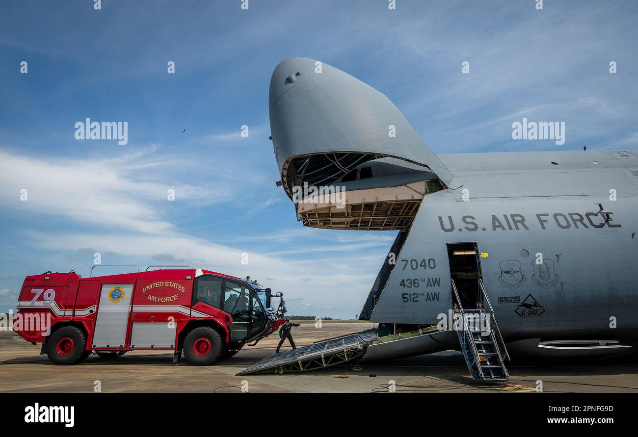 A P-23 fire truck rolls toward a C-5M Super Galaxy to be loaded in April 5 at Eglin Air Force Base, Fla.  The 39-foot-long, 12-foot-tall, 10-foot-wide truck fit easily in the belly of the Air Force’s largest aircraft.  The 436th Airlift Wing aircraft flew to Eglin for some heavy cargo training for Air Force and Army aerial porters and loadmasters.  More than 150,000 pounds of equipment was loaded, secured and offloaded in only a few hours.  (U.S. Air Force photo/Samuel King Jr.) Stock Photo