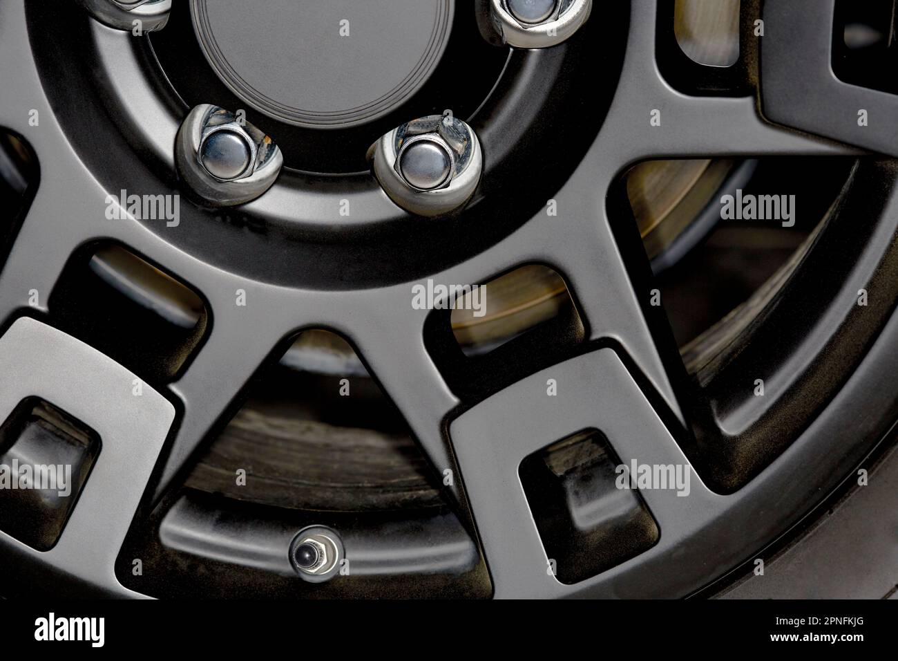 Close up of a Black Car Wheel Rim with Chrome Lug Nuts Stock Photo - Alamy