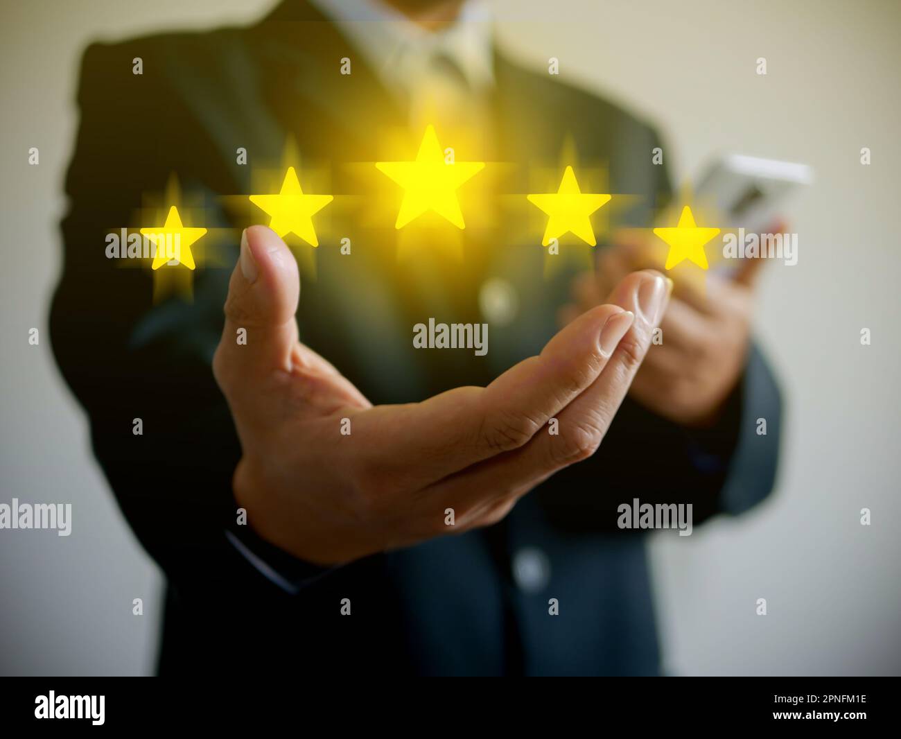 Hand of businessman giving five stars for his full satisfaction. Providing a five star rating. Service rating and customer, client, business evaluatio Stock Photo