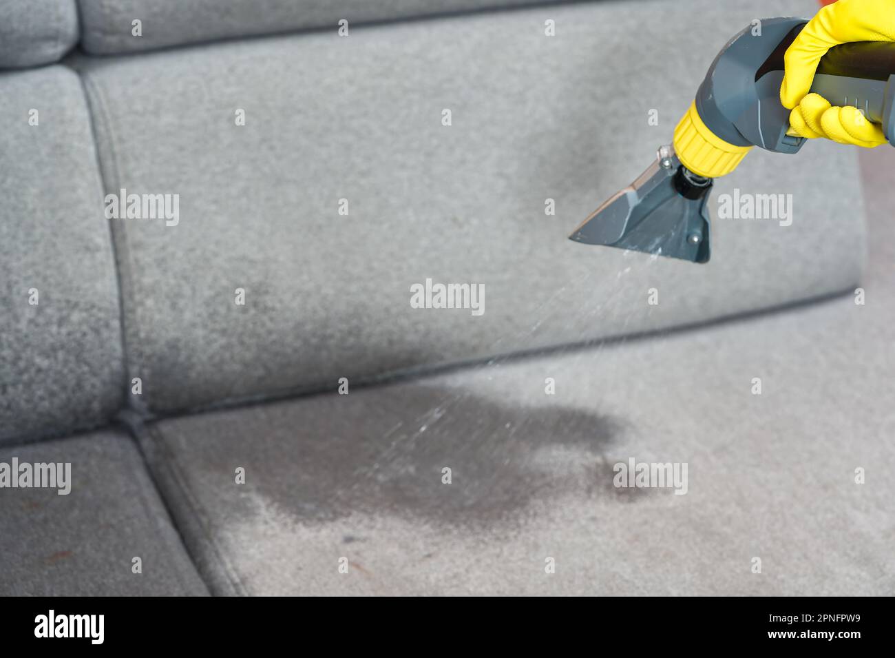 Sofa chemical cleaning with professionally extraction method. Wet textile sofa cleaning Stock