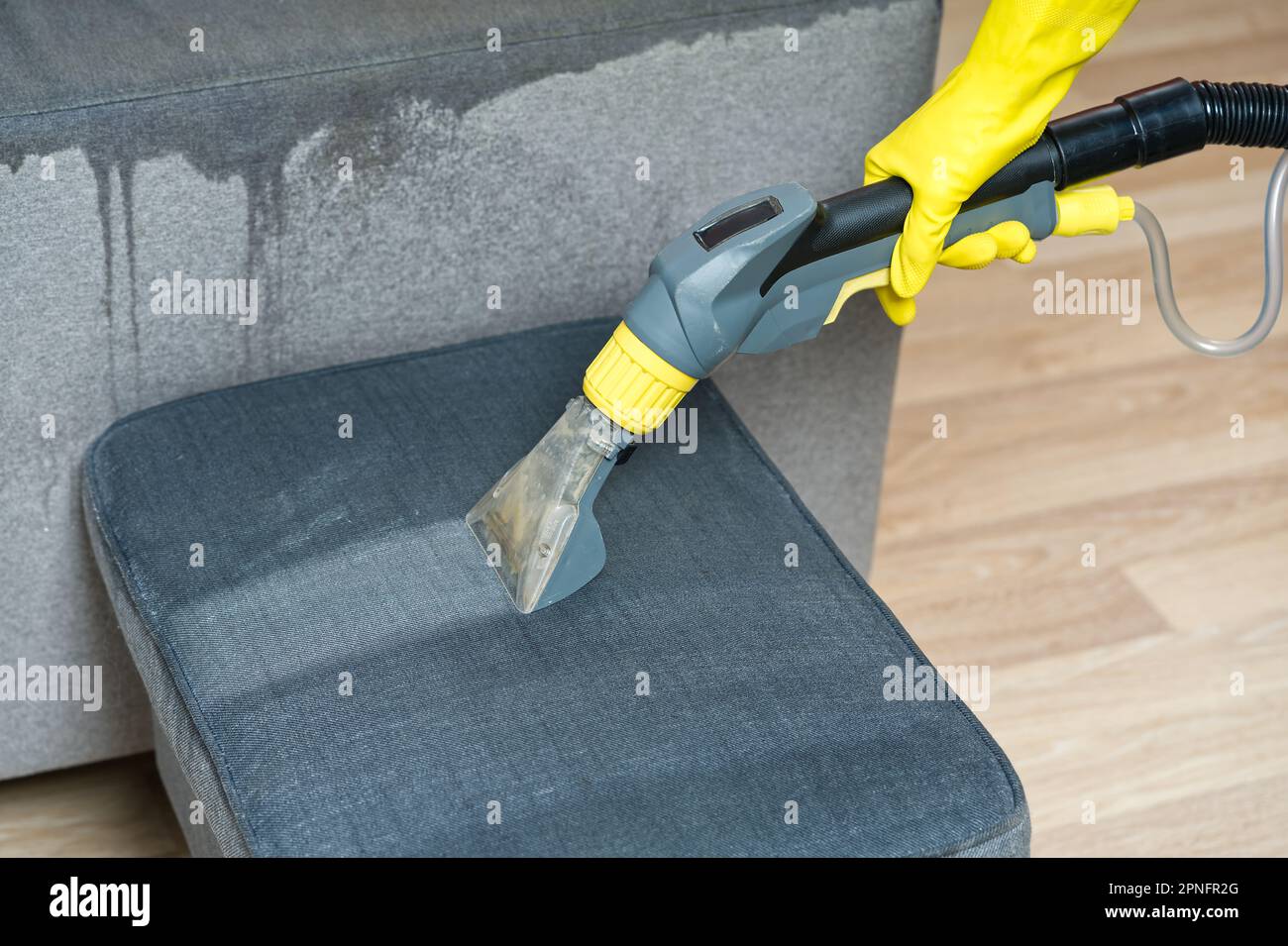 Sofa chemical cleaning with professionally extraction method. Wet