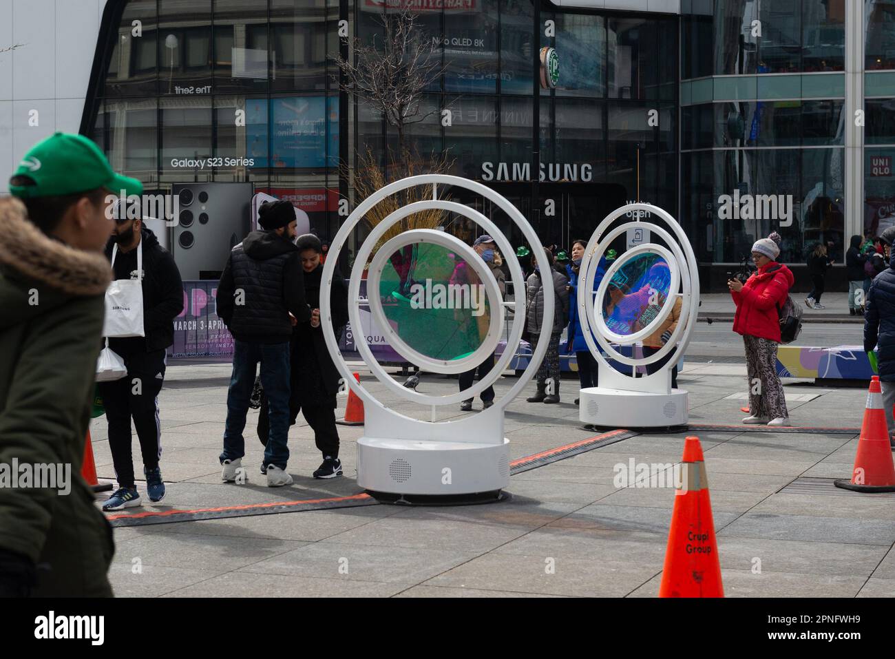 Toronto, ON, Canada - March 19, 2023: People viewing the Optik interactive installation in Downtown Toronto. Optik is inuque platform for users to man Stock Photo