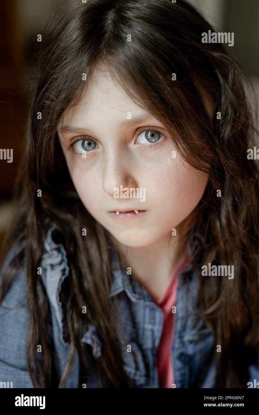 Girl with false vampire teeth Stock Photo - Alamy