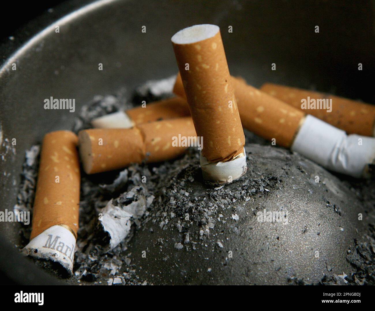 Cigarettes stubbed out in an ashtray hi-res stock photography and images
