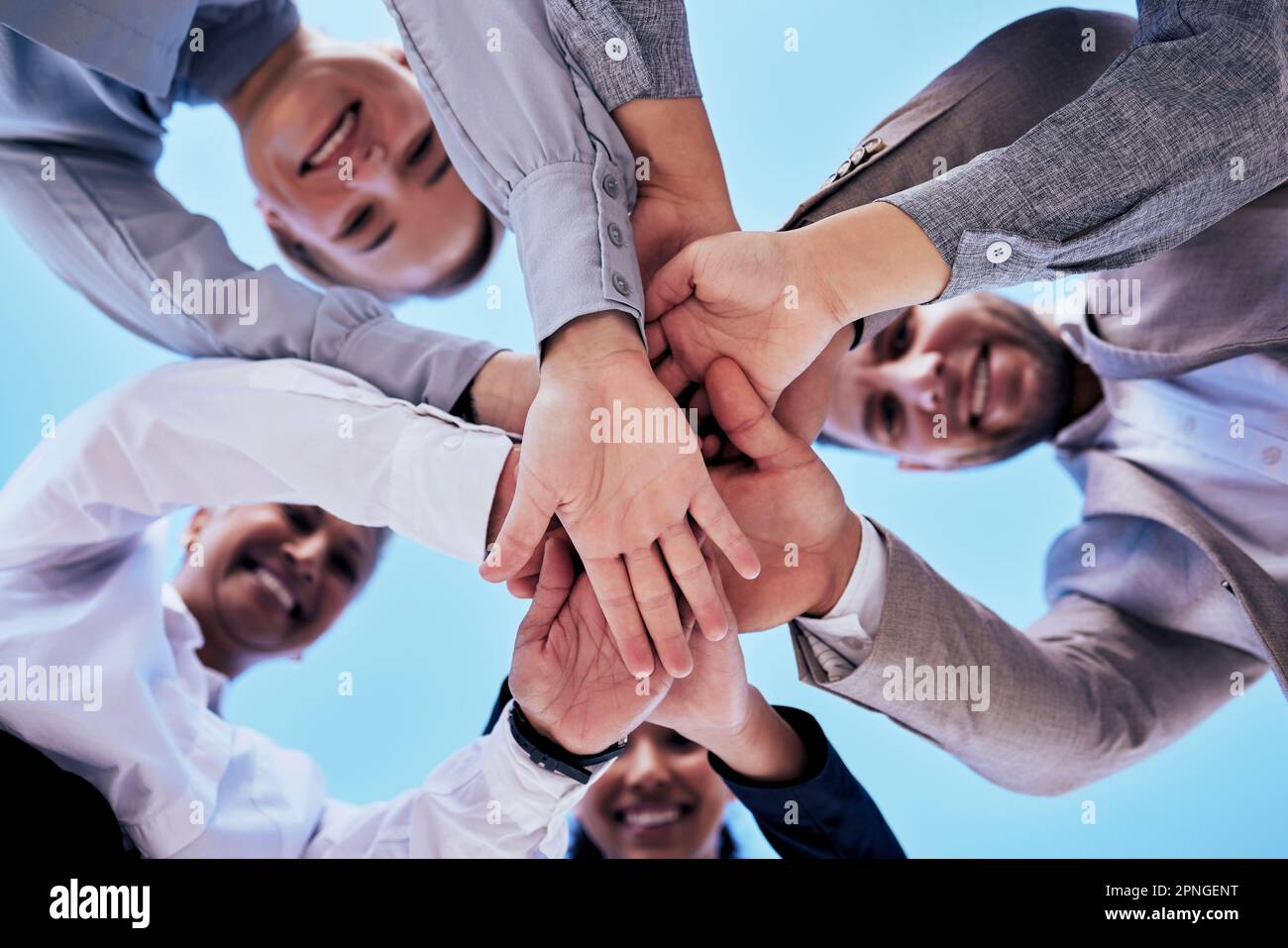Business people, hands together and teamwork in unity below blue sky ...