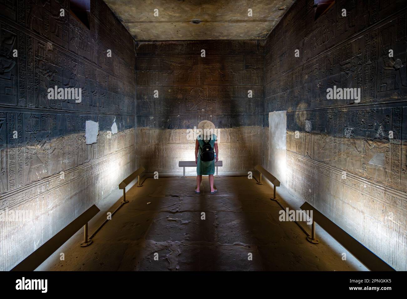 aswan-egypt-person-examining-old-hieroglyphs-inside-the-temple-of