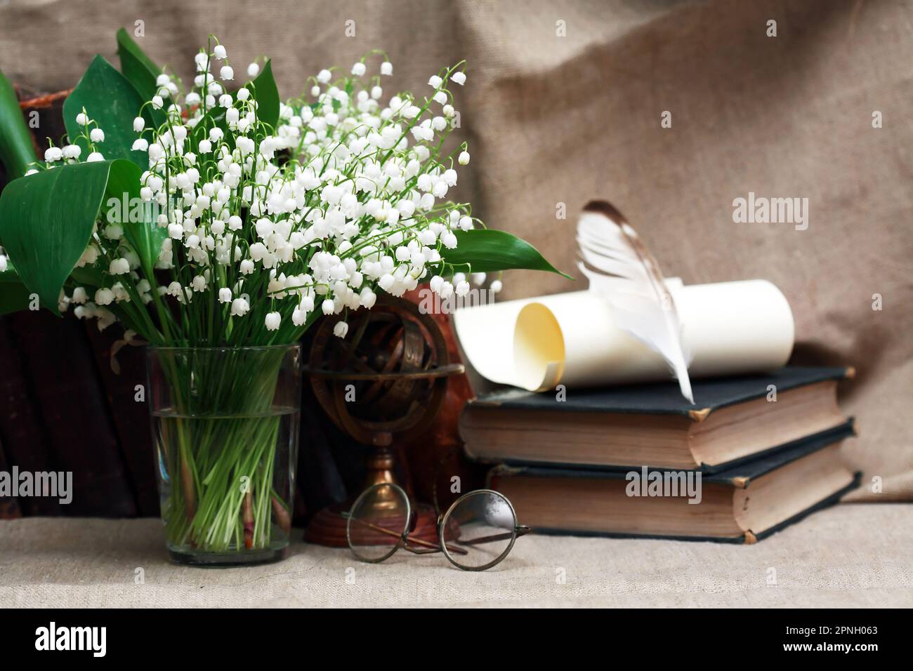 Still life with open book and quill pen near posy of white lilies Stock ...