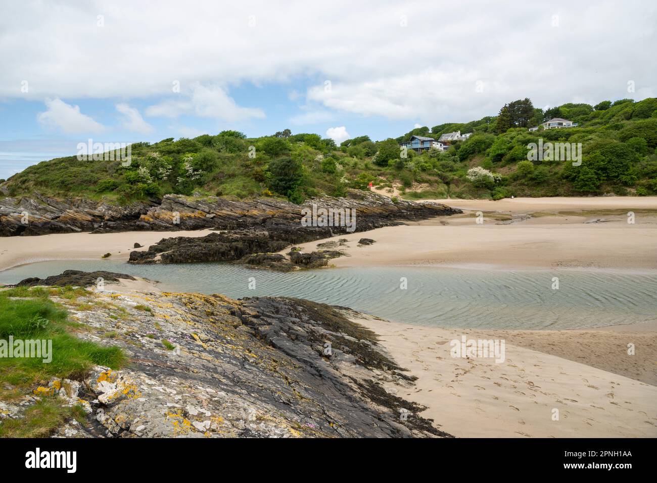 Sandy beach near BorthyGest, Porthmadog, North Wales. Houses above