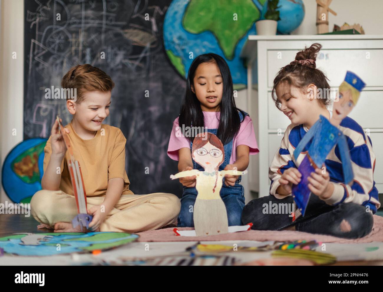 Little children playing with a handmade puppets Stock Photo Alamy