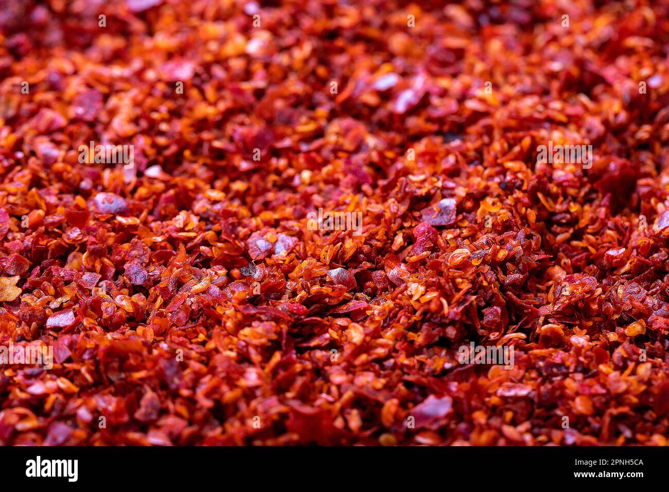 Red chili flakes. Crushed chili pepper or dried chili flakes background. Spices background