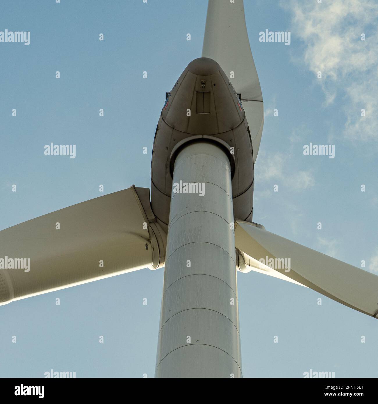 'Renewable energy in sight: The majestic wind turbine towering over the landscape, providing clean energy for a more sustainable future.' Stock Photo