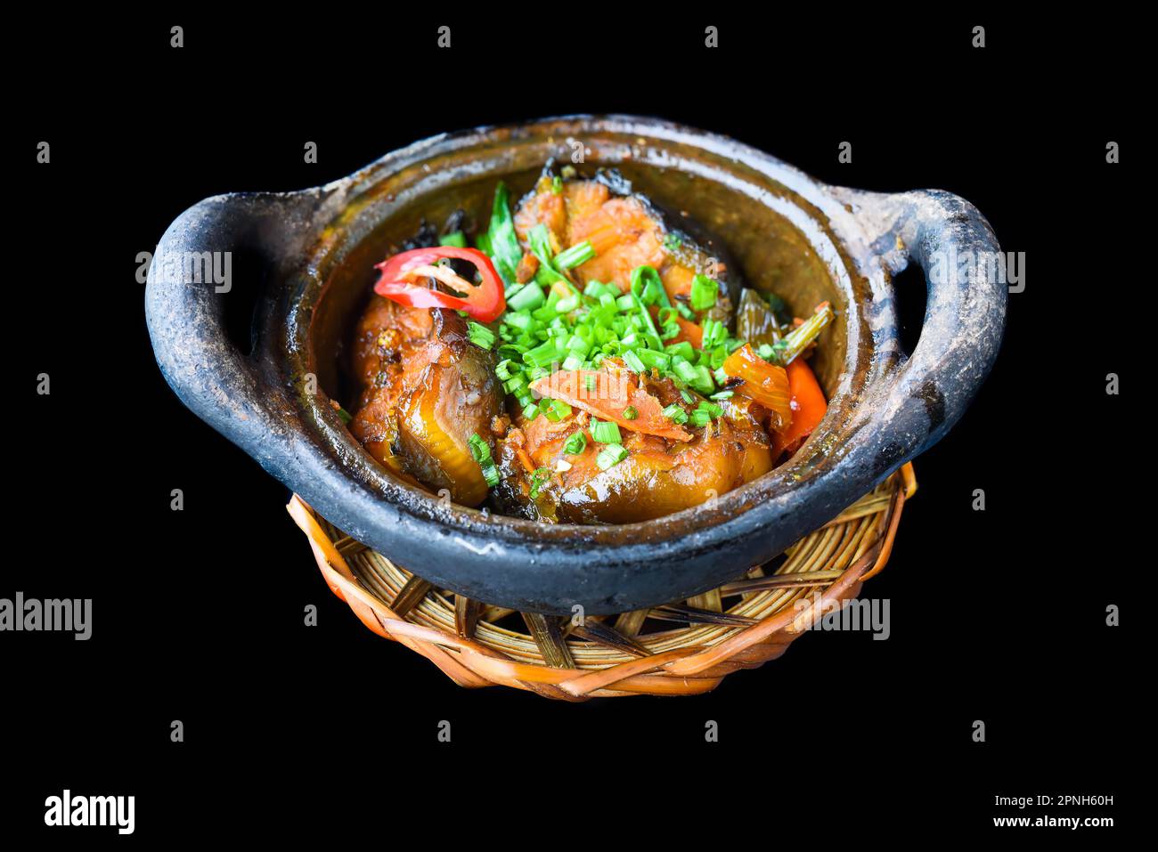 Vietnamese fried Mackerel fish with sauce on black background Stock