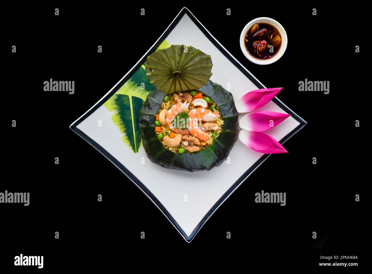 Vietnamese fried rice with vegetables, nuts and shrimps in lotus leaf ...